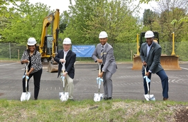 Image of four officials with shovels breaking ground