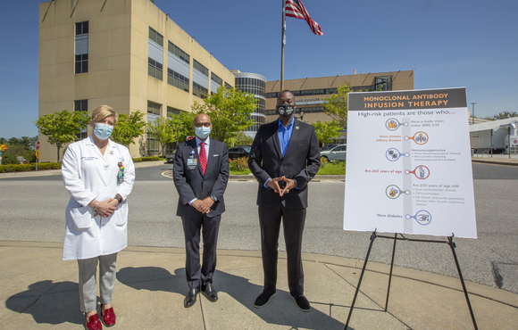 Calvin Ball and howard county general hospital officials standing in front of hospital