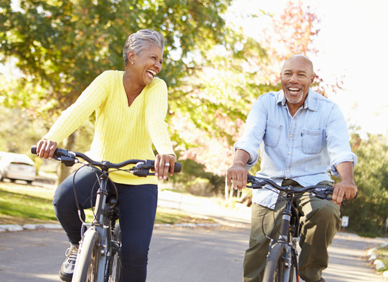 senior man and woman riding bicycles