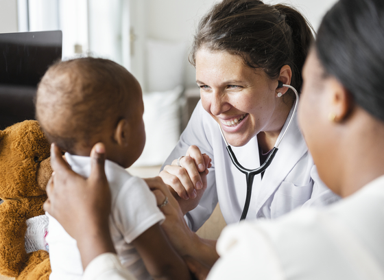 woman doctor examining a child