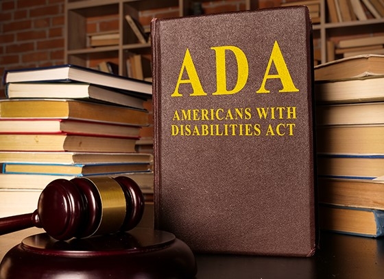 Books with ADA Print on the cover and a gavel.