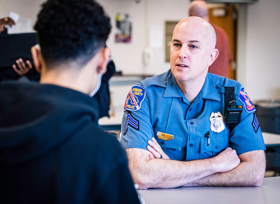 An HCPD officer meets with a student.