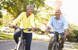 senior man and woman riding bicycles