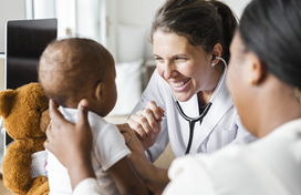 woman doctor examining a child
