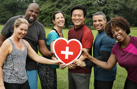 group of people holding a paper heart