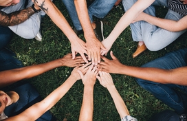 group of people putting their hands together