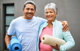 older couple with yoga mats